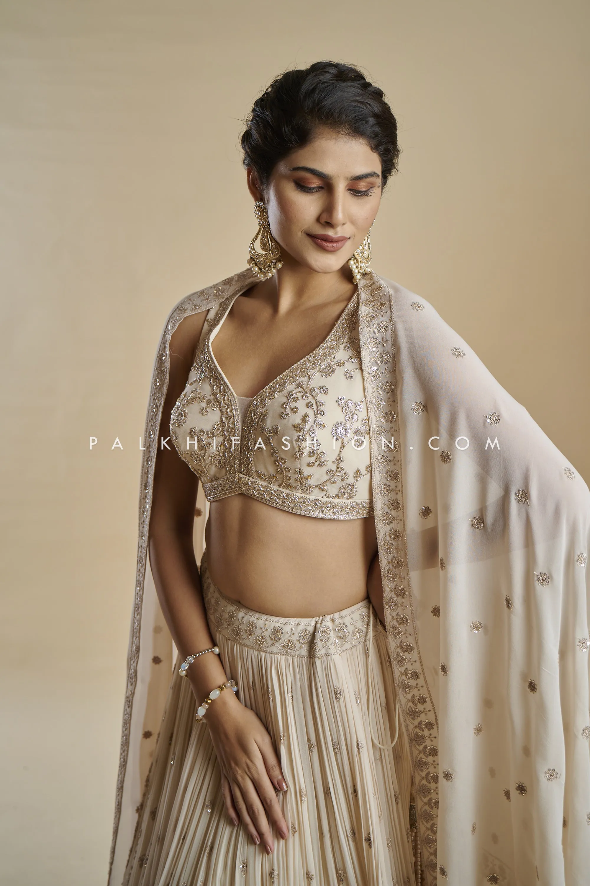 Imperial Charm: Exclusive Champagne Lehenga Choli with Handwork